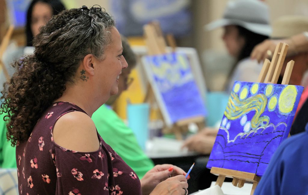 Starry Night Paint and Sip participant creates a masterpiece